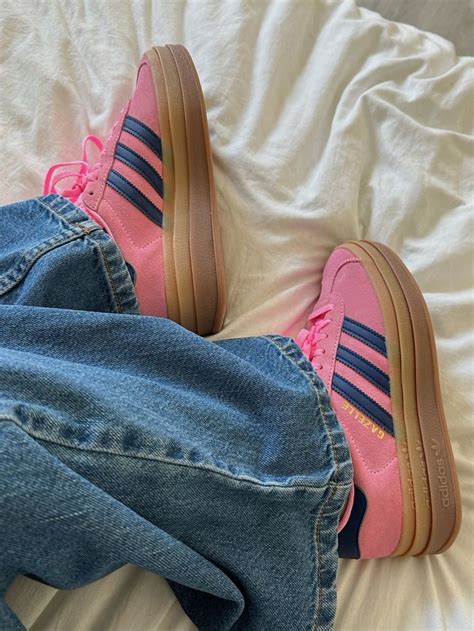 green and pink adidas sambas.